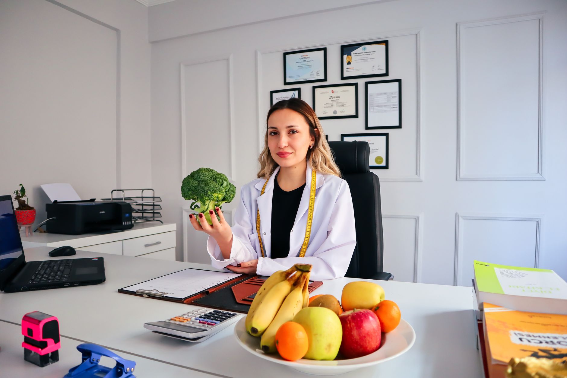 A clinical nutritionist selecting fresh healthy green components